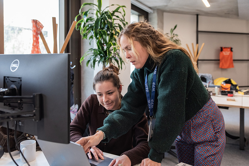 Two women collaborating in WPP Media offices