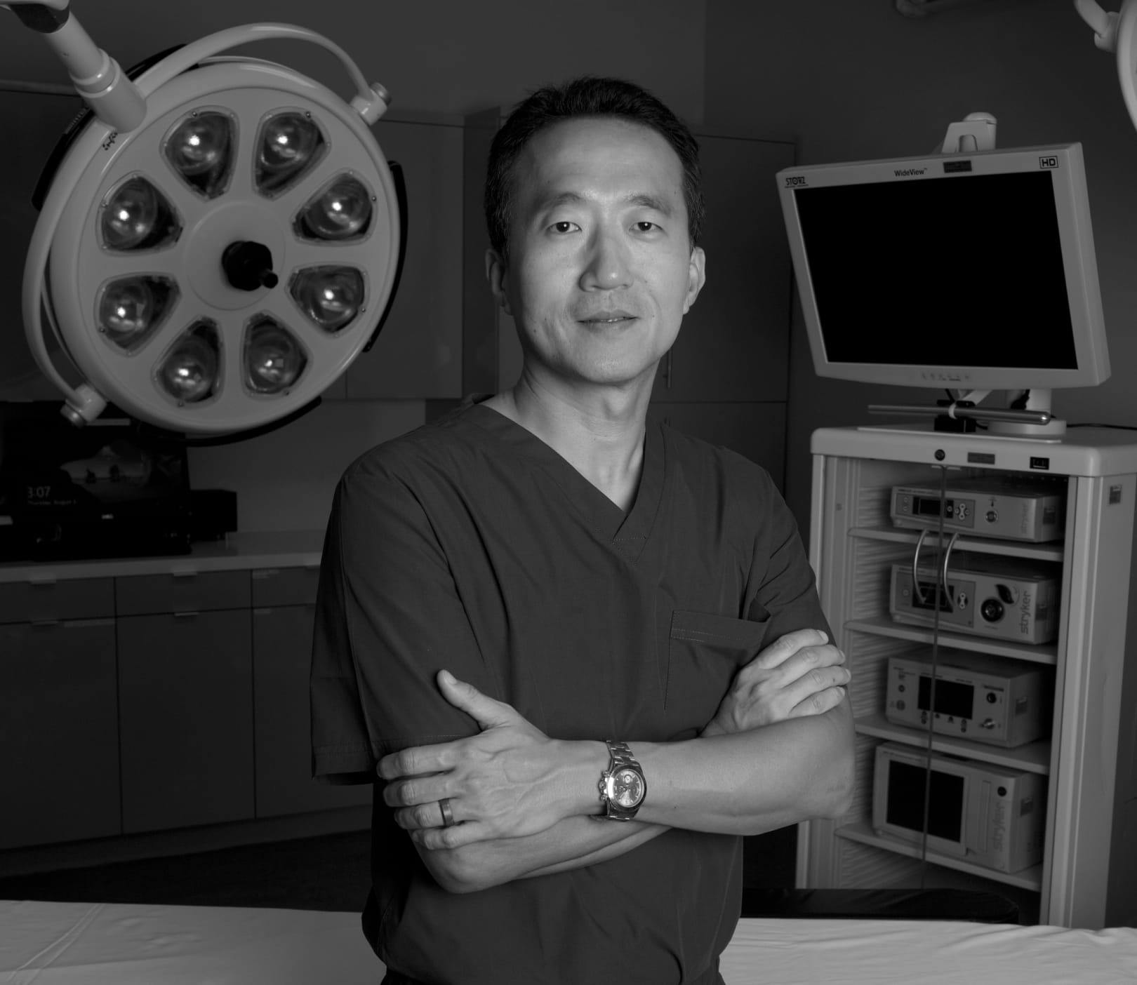Black and white image of Dr. KAHNG in his surgical room
