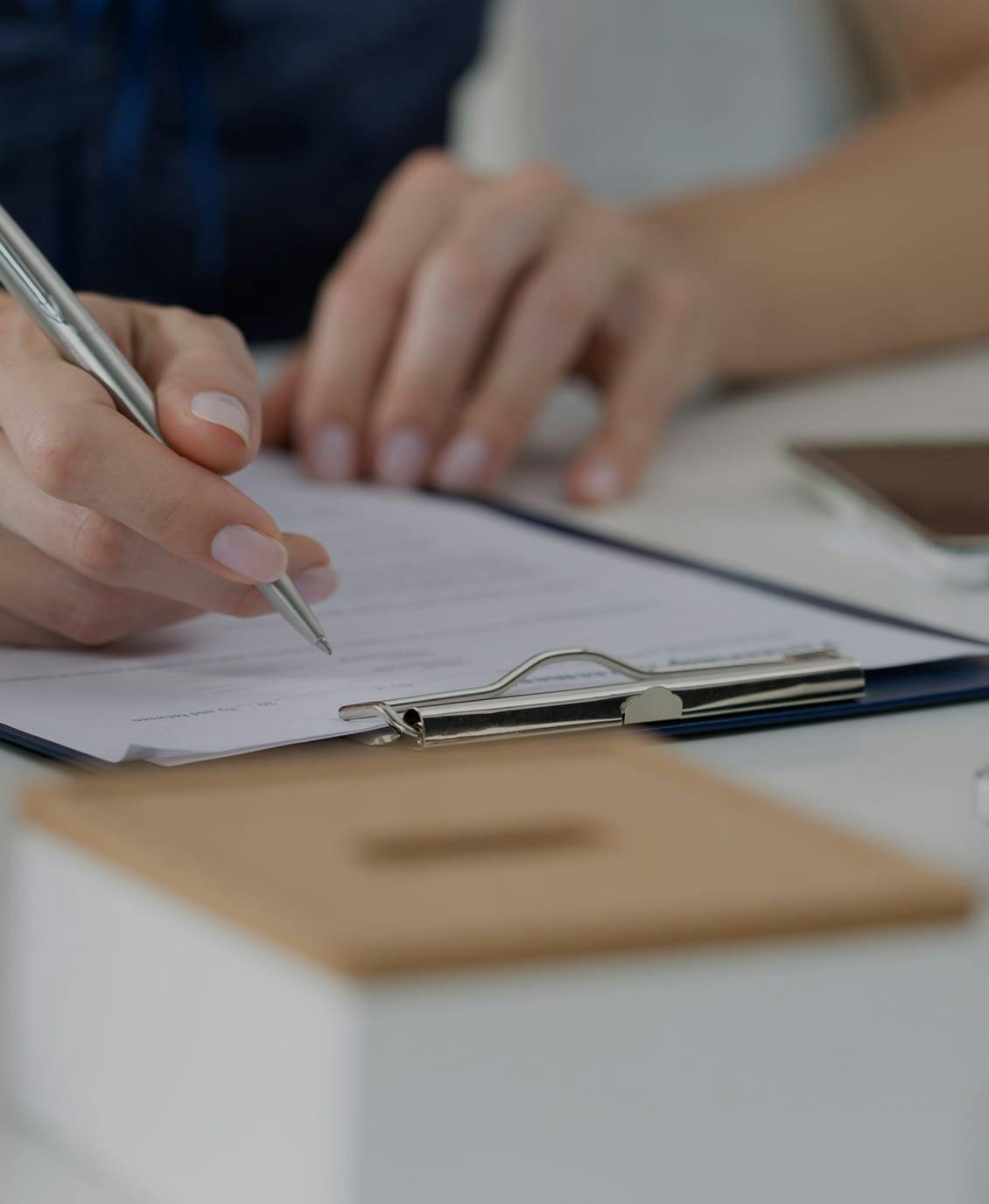 someone signing paperwork