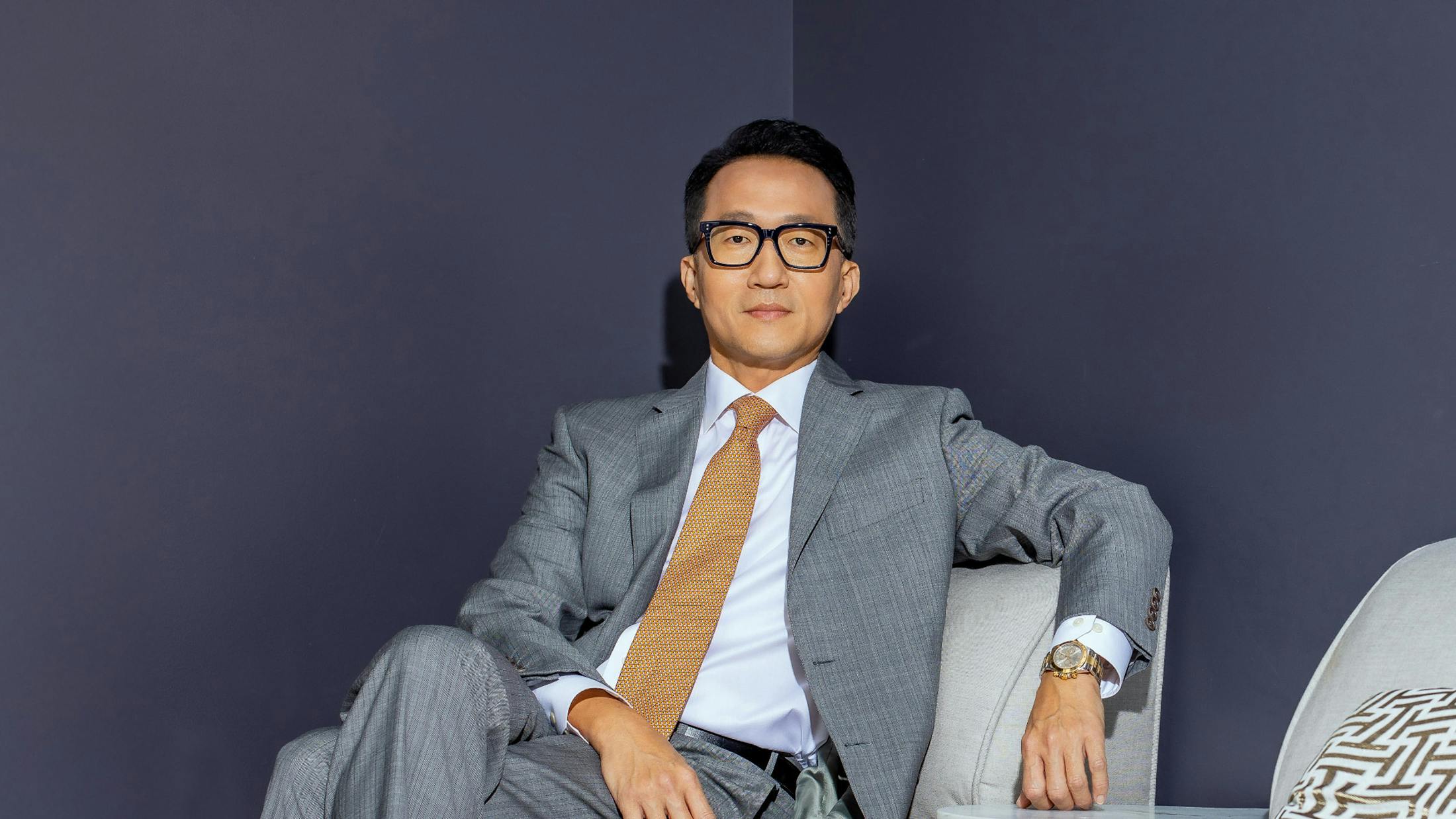 Dr. Kahng sitting on a couch