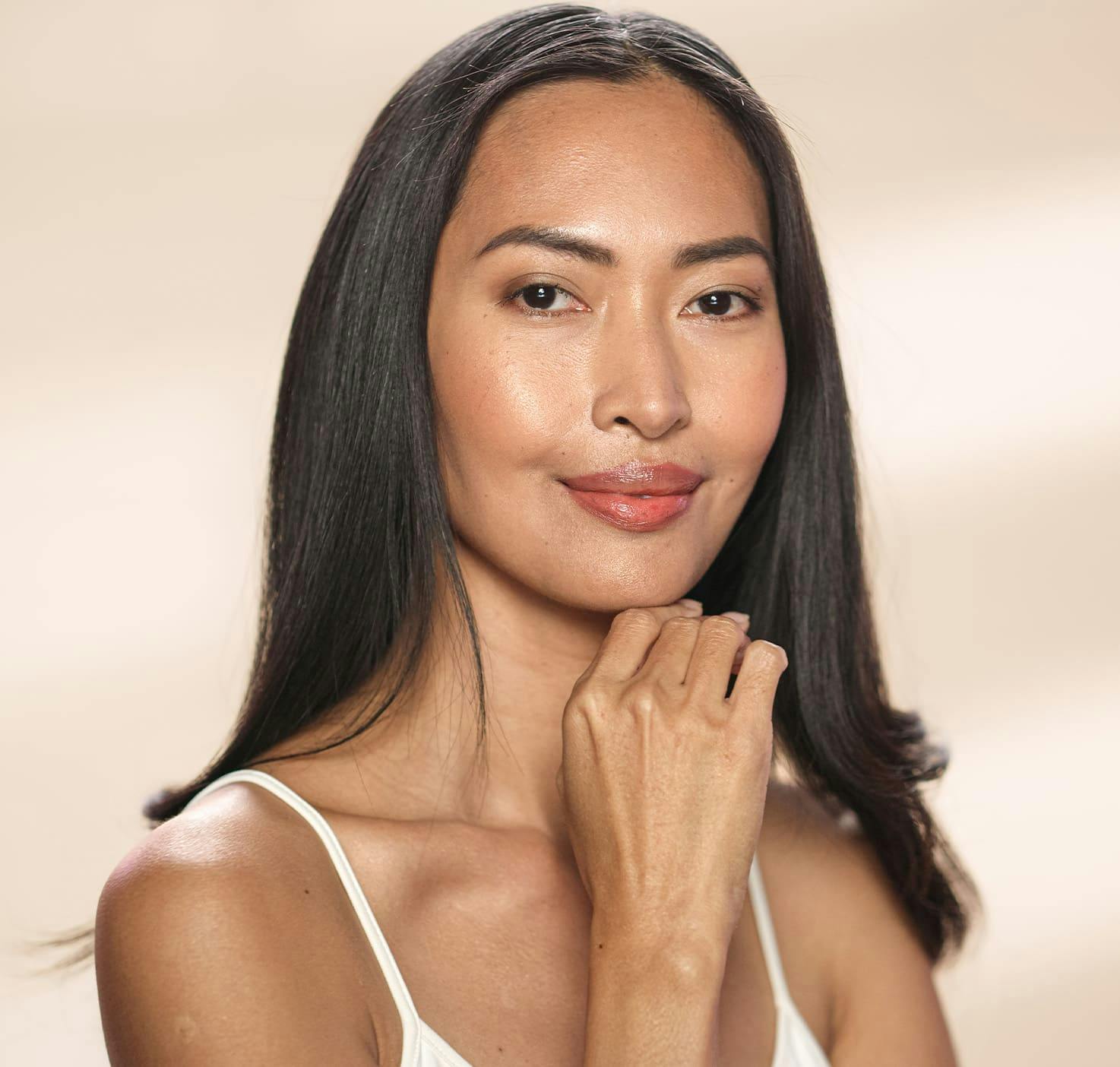 Woman smiling with hand on chin