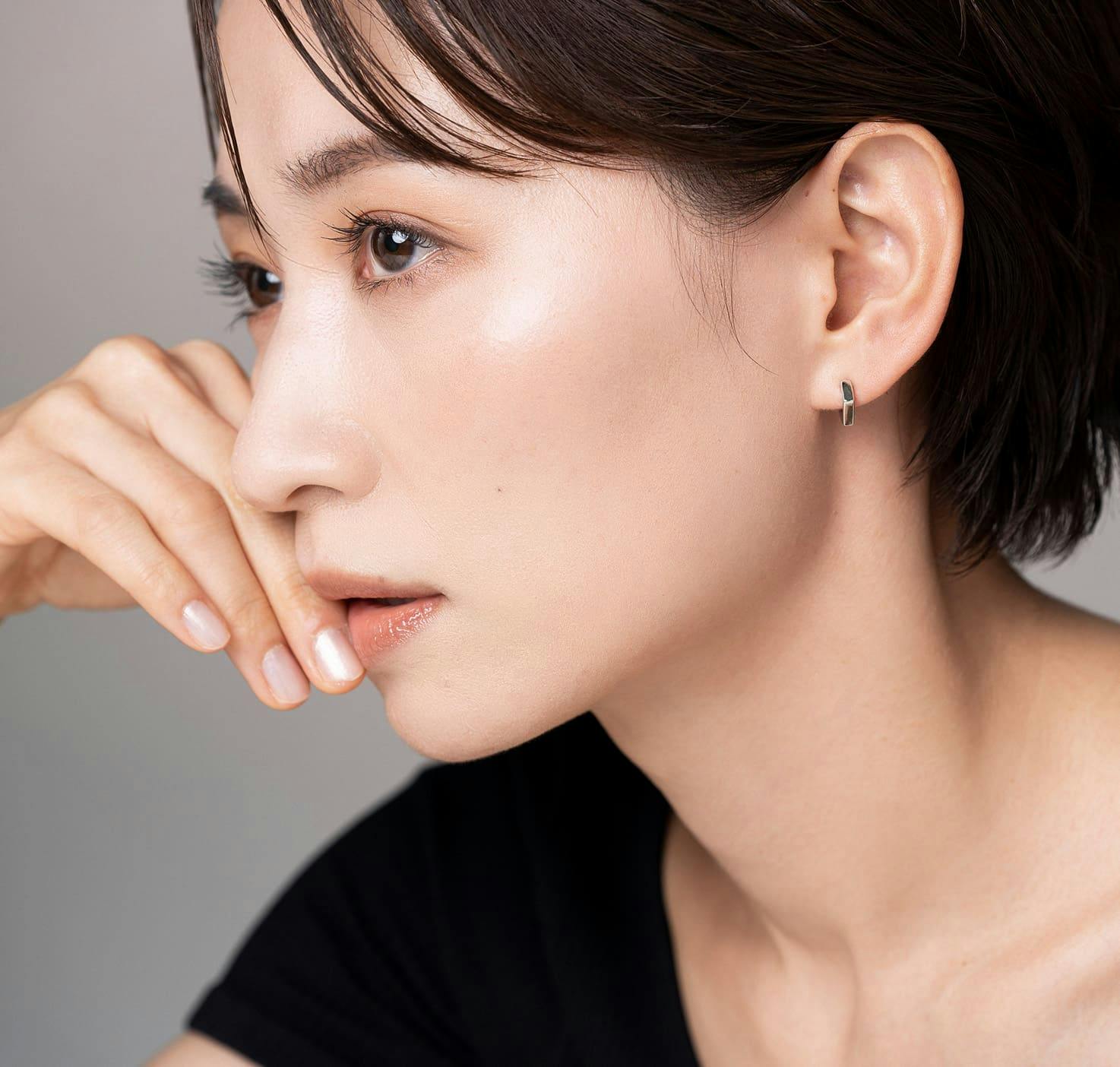 woman resting cheek on hand looking left