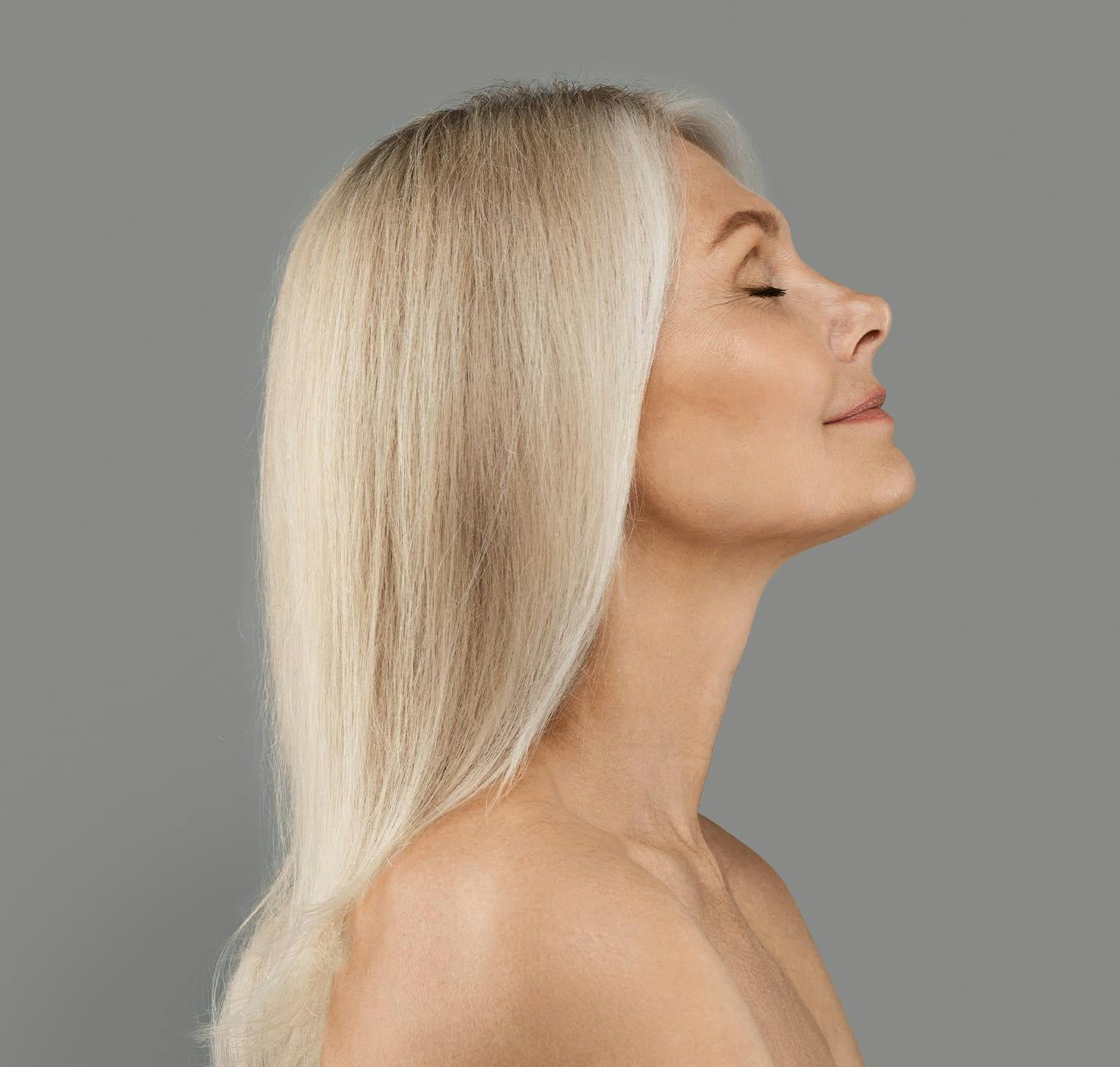 woman side profile with her head tilted upwards