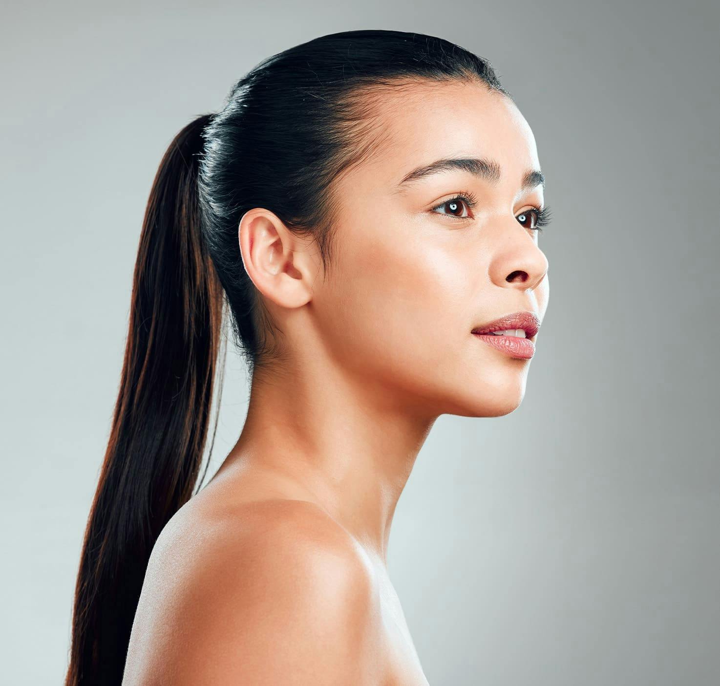 black haired woman with ponytail looking to the left