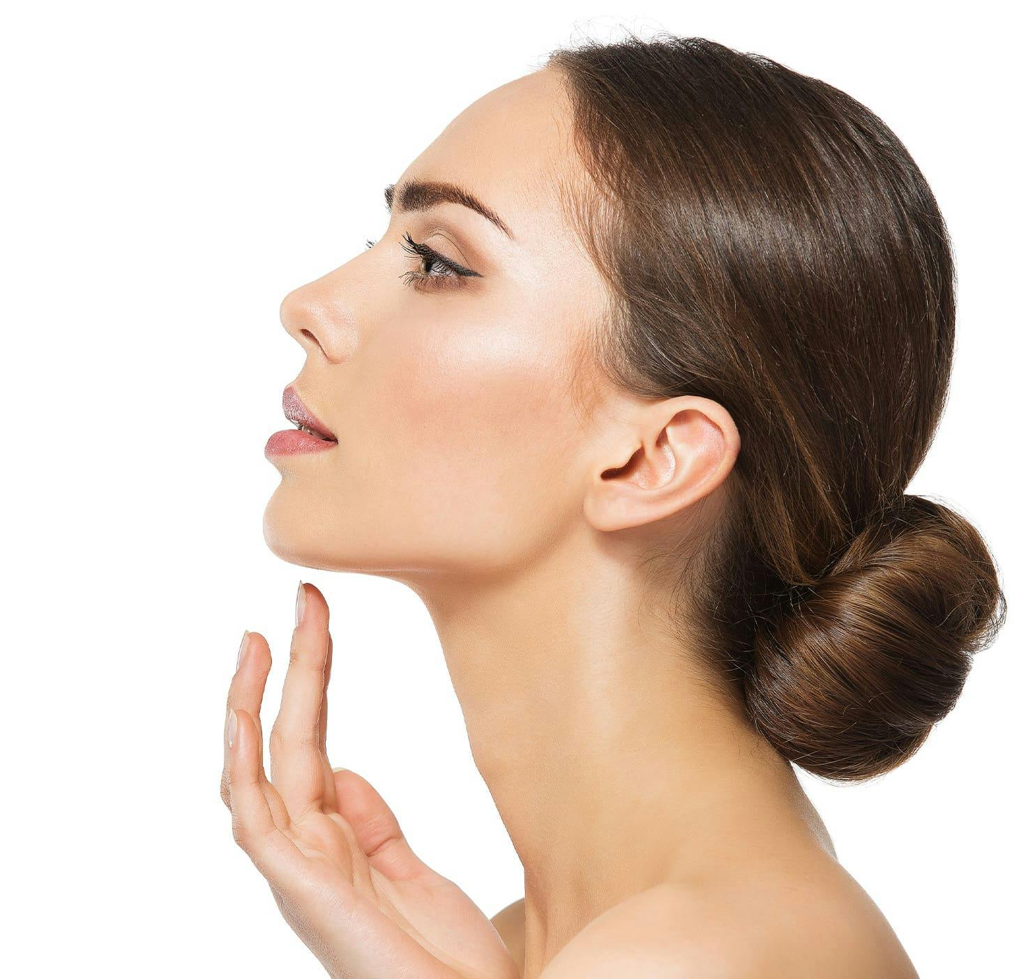 profile of womans face with her hair in a bun