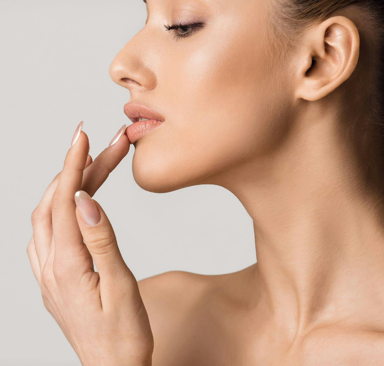 woman with long nails touching her lip