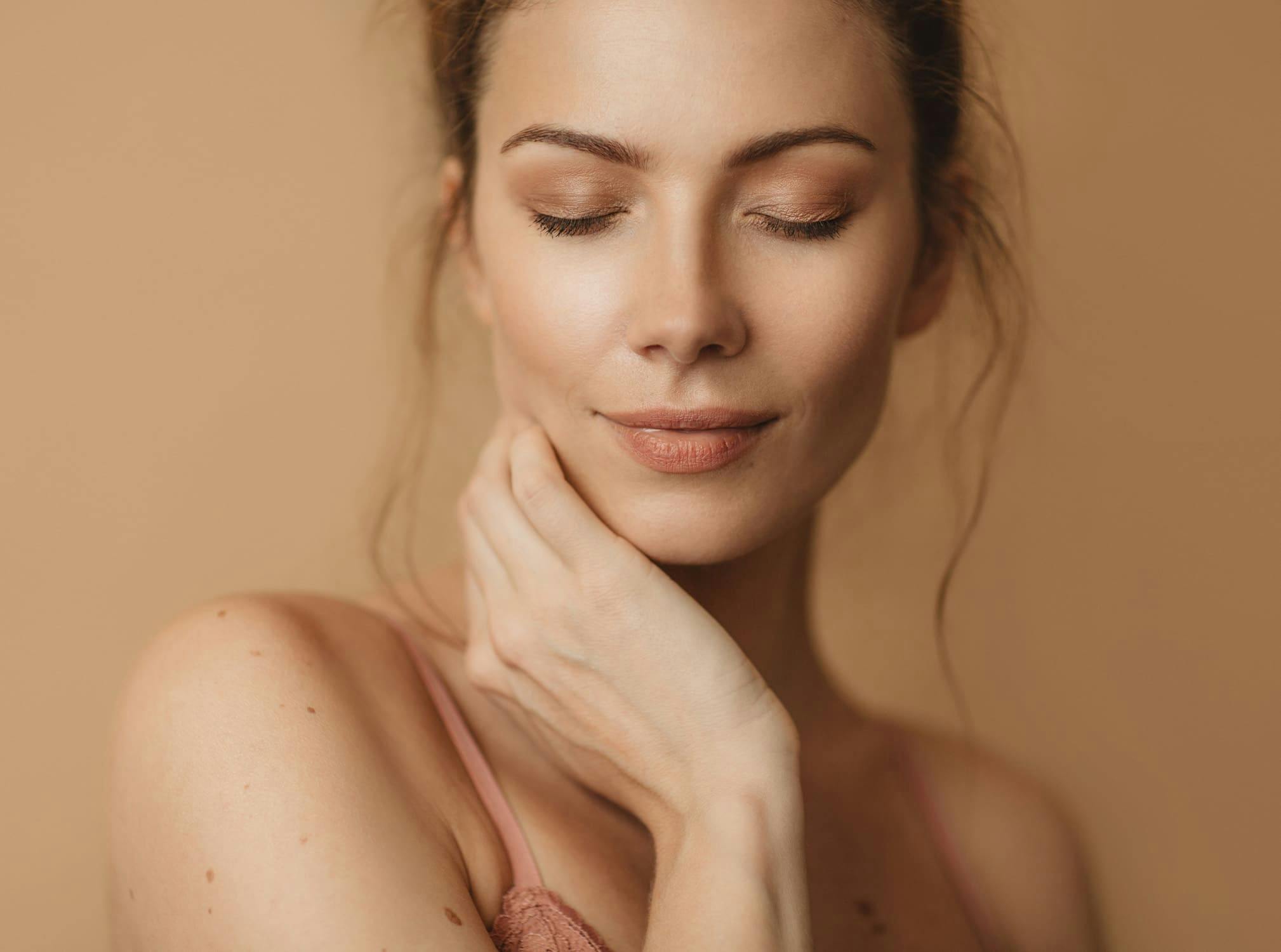woman resting hand on chin with eyes closes