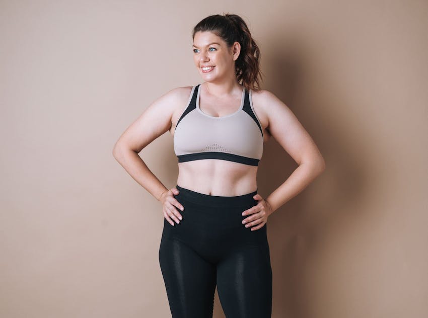 Woman with hands on hips smiling