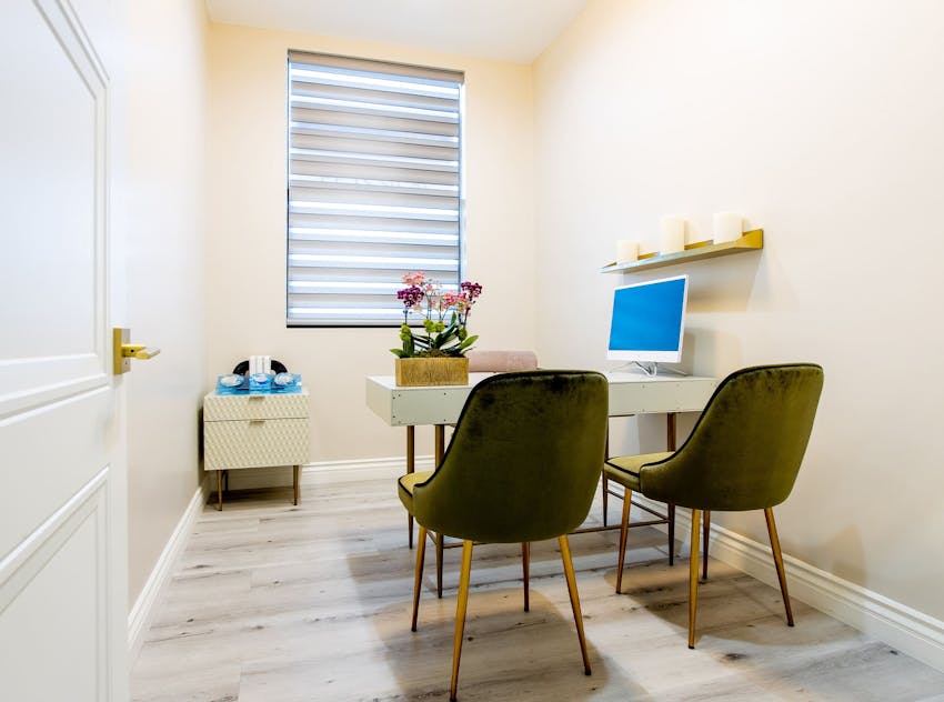Office chairs at a desk with a desktop computer