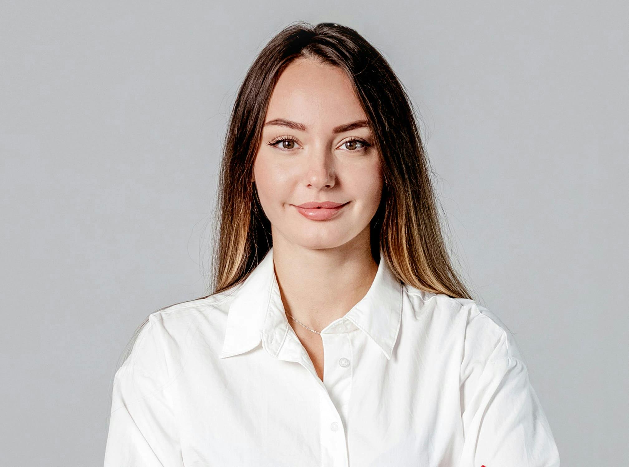 woman smiling in white button down