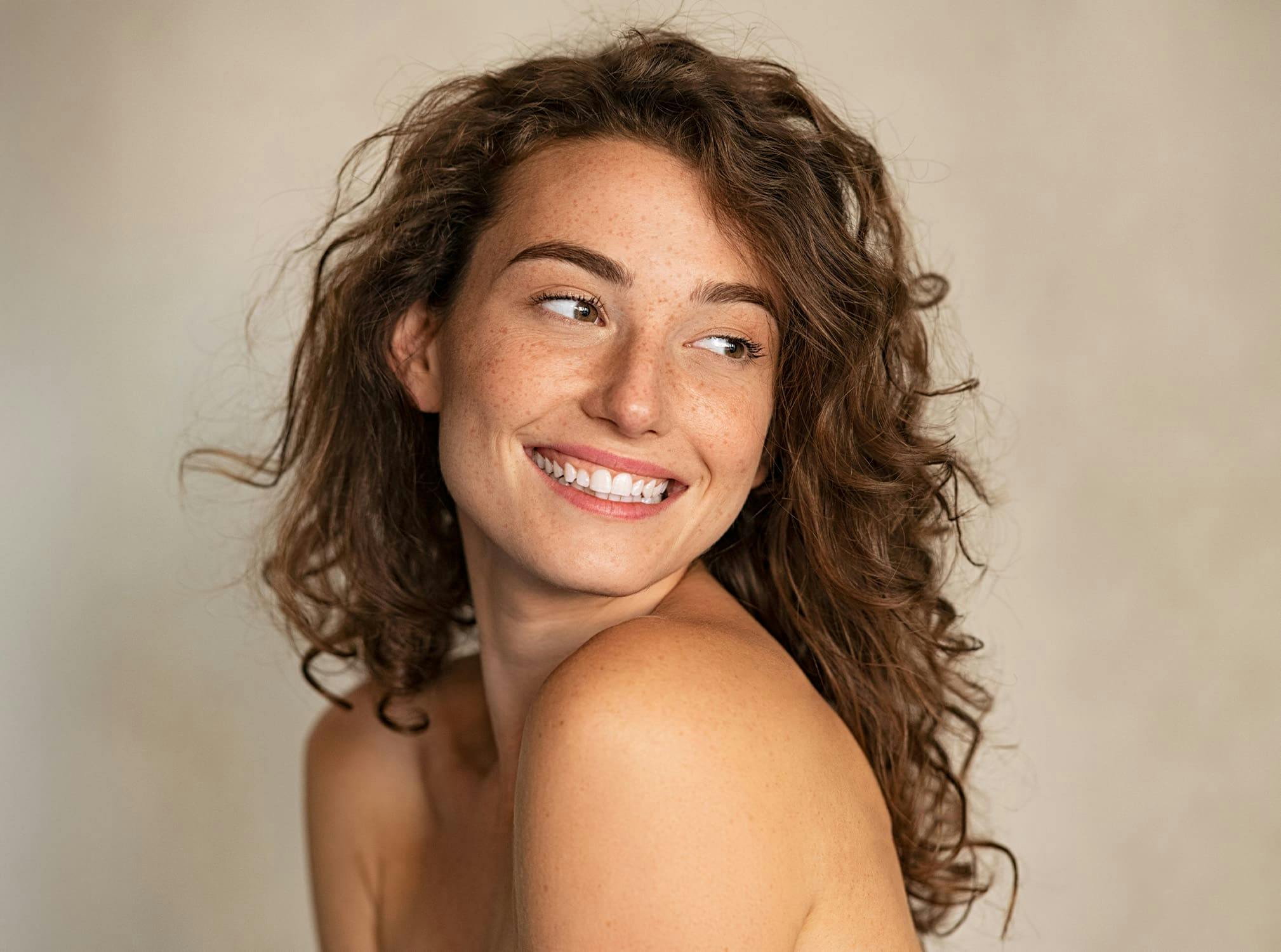 curly haired woman smiling