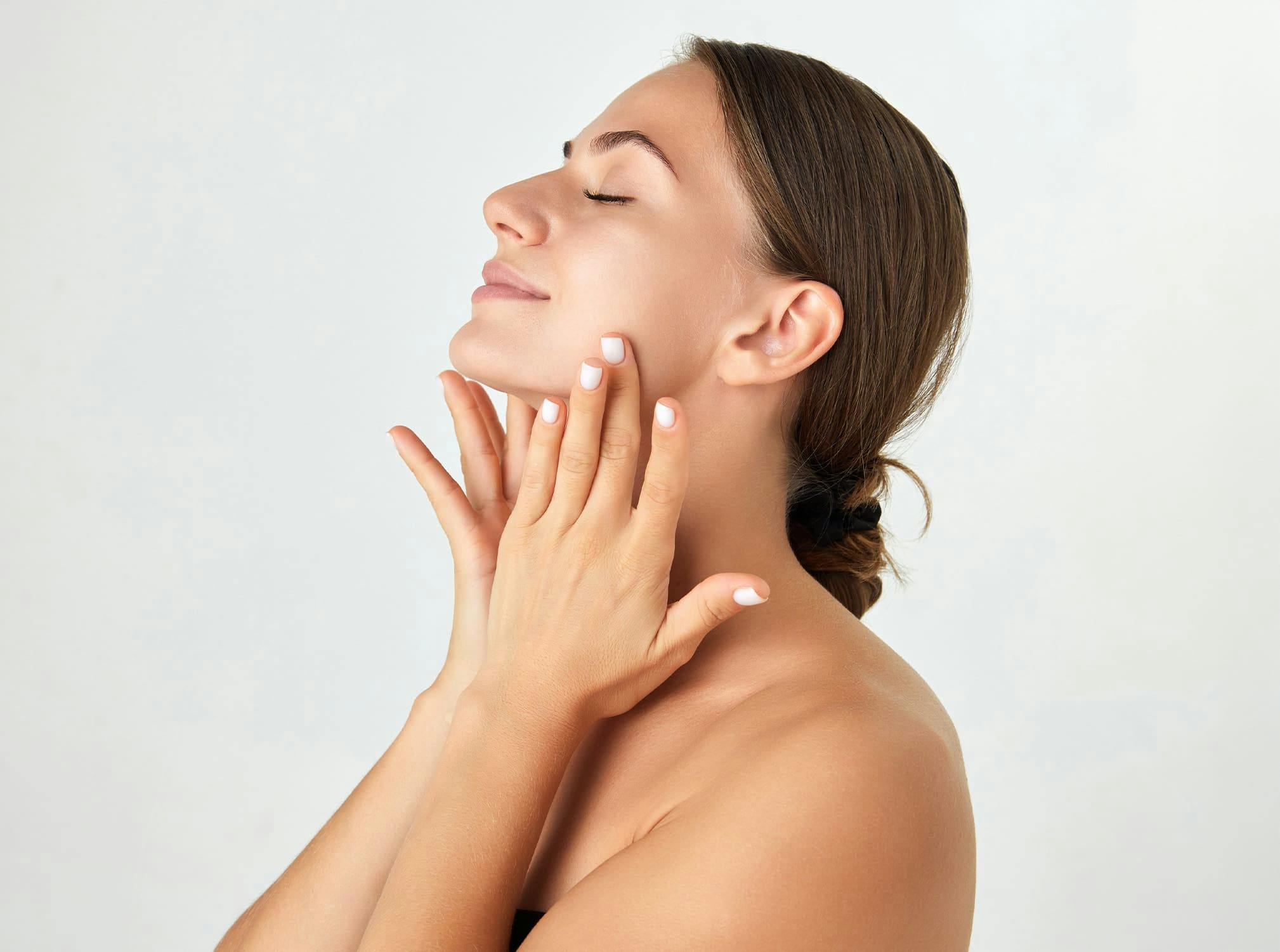 woman touching face with both hands