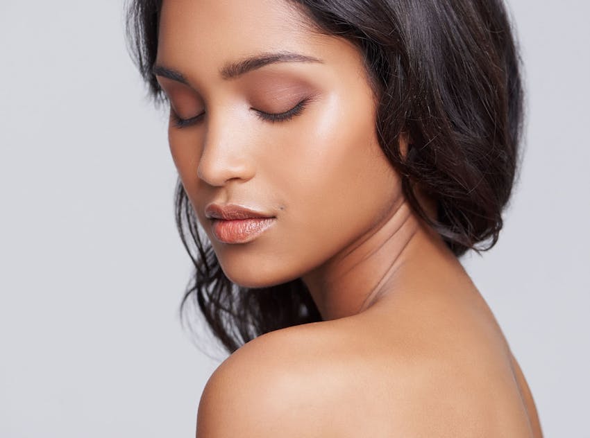 Woman looking down at shoulder