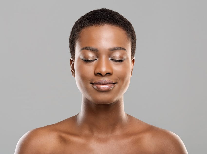 short haired woman smiling with eyes closed