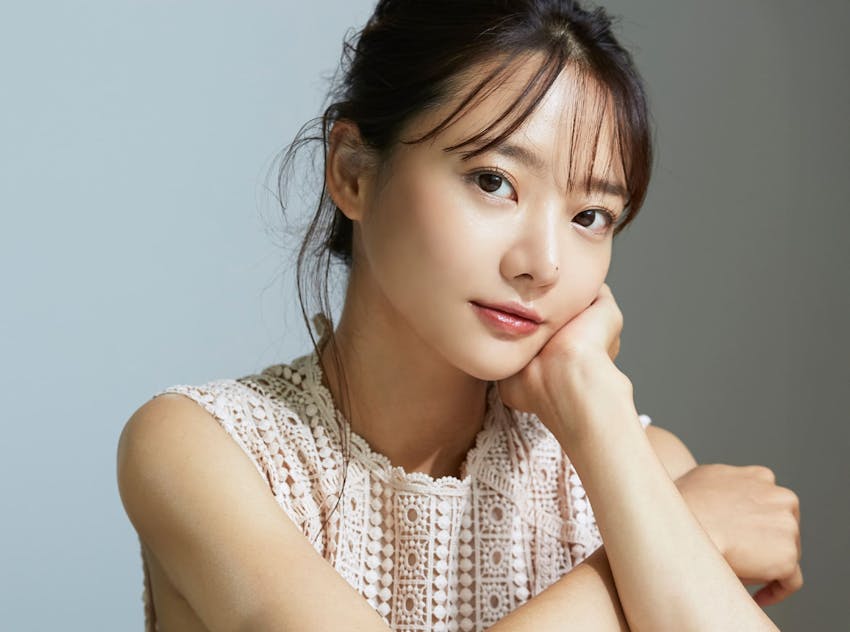 woman resting chin on hand