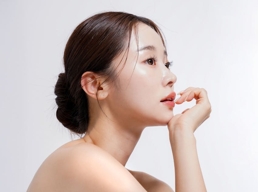 Asian woman with chin resting on hand