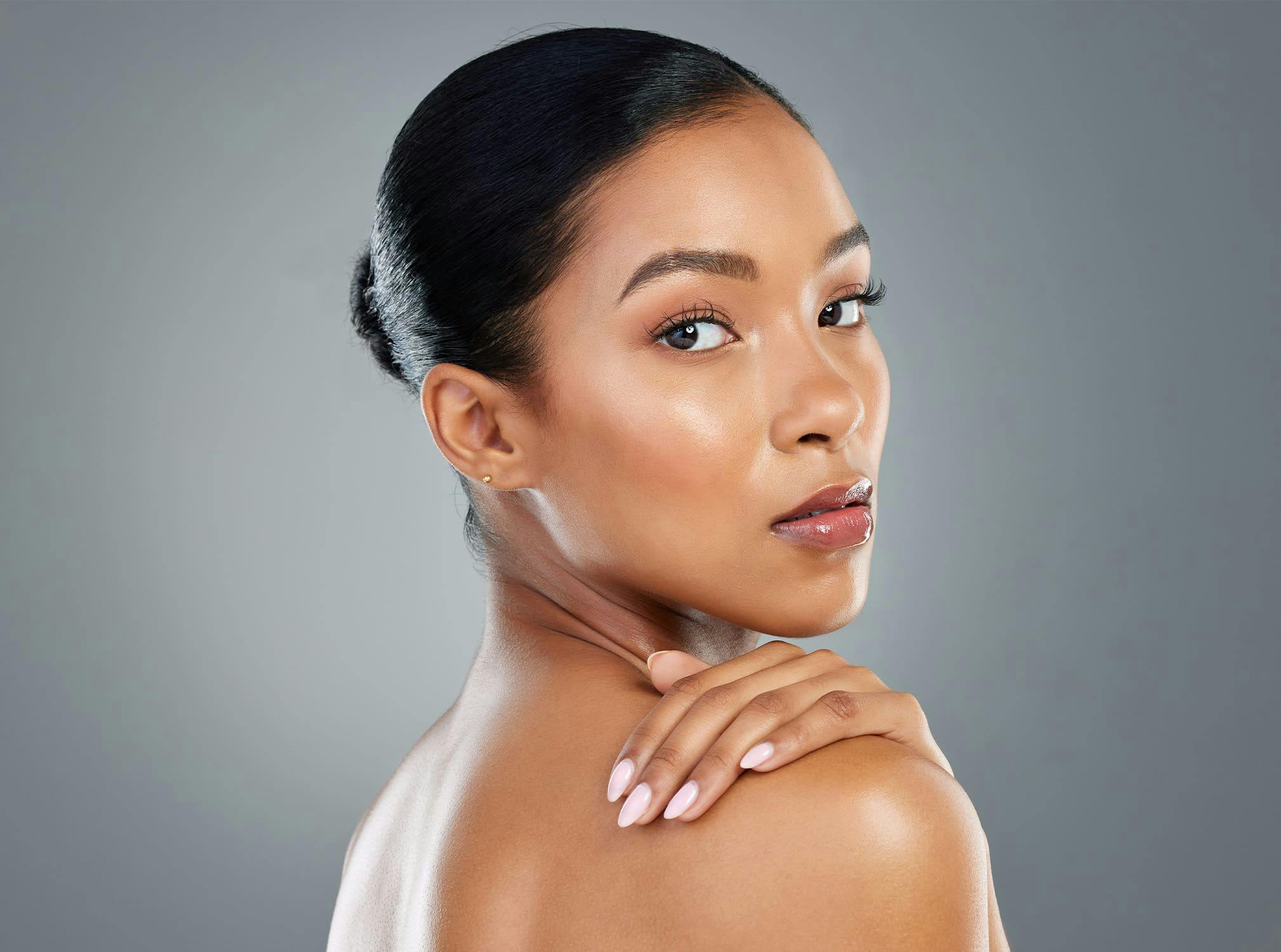 woman wearing makeup looking over shoulder