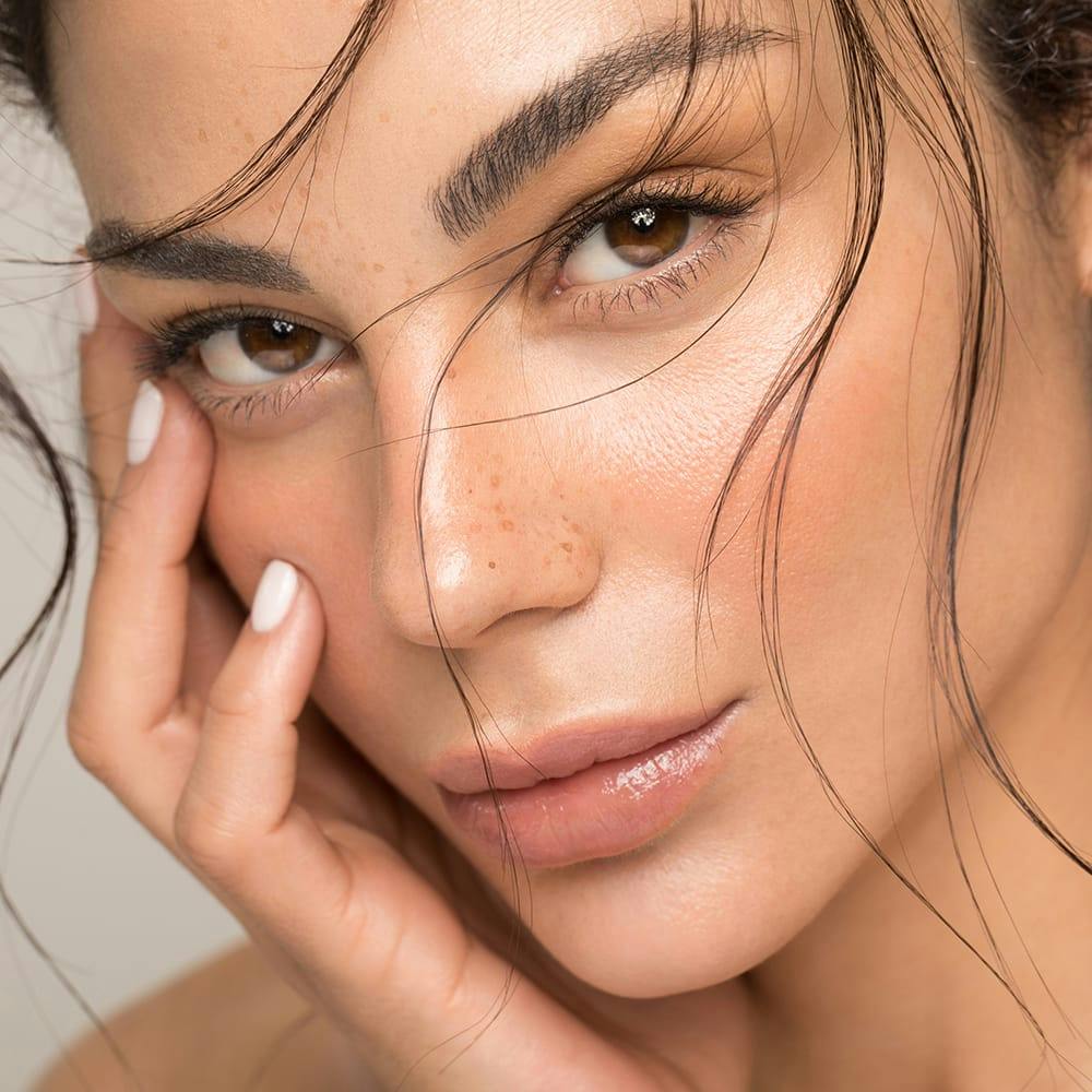 woman touching the side of her face