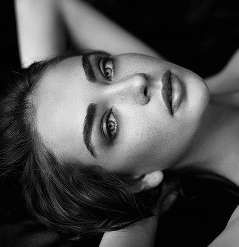black and white image of a woman with freckles