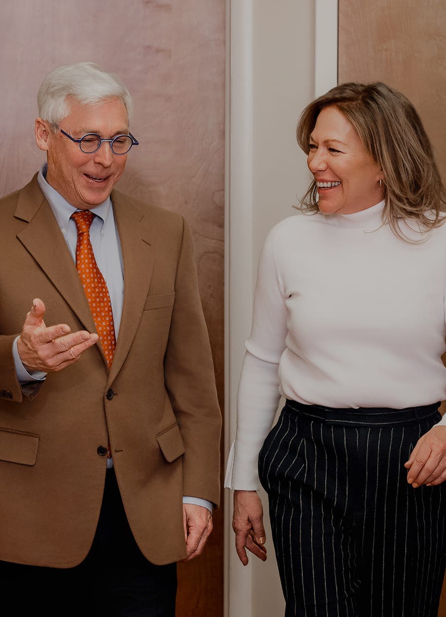 Dr. Stephen E. Small and a woman talking and laughing