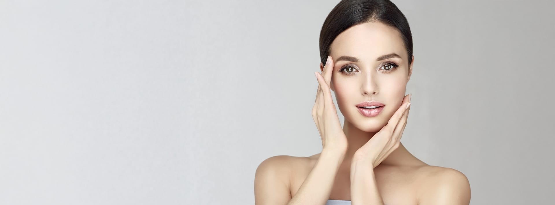 Woman smiling with hands on her face