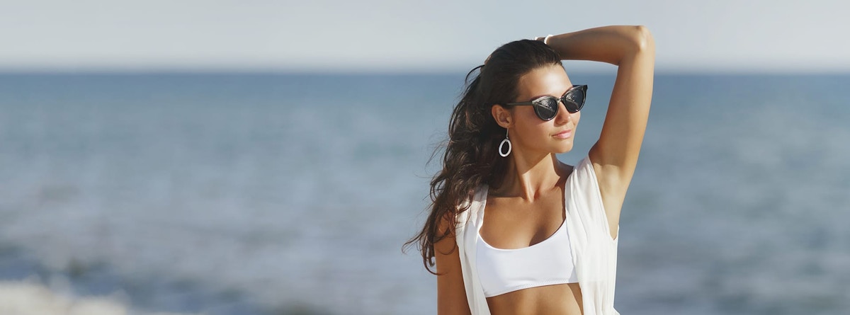 woman brushing her hair back
