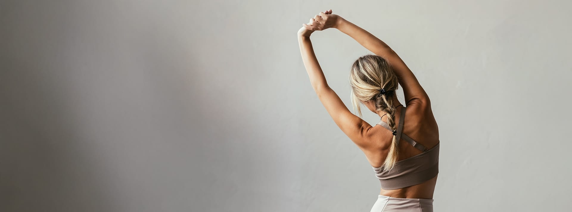 woman stretching with her arms raised