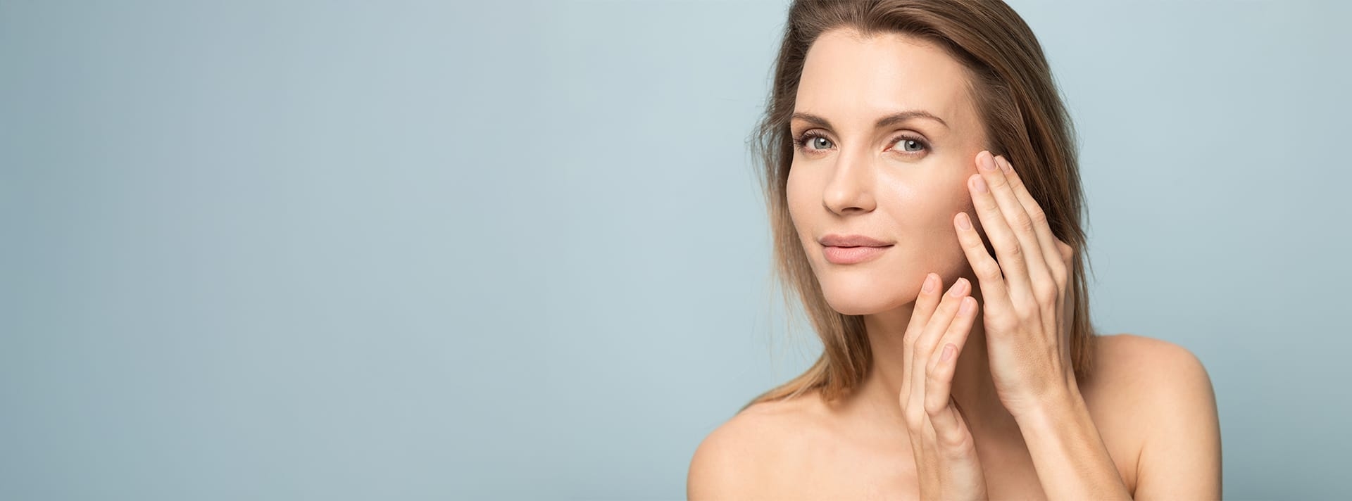 woman with her hands posing around her face