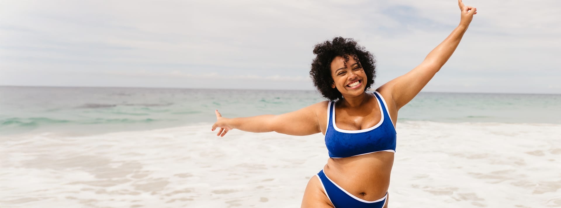 woman on the beach in blue bikini