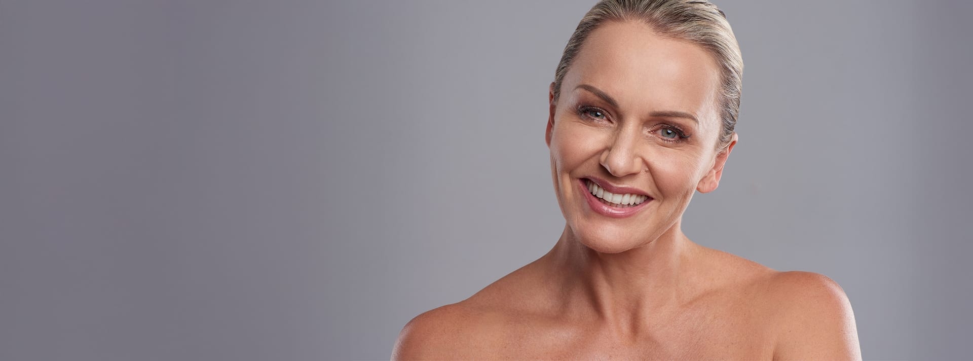 women with her hair tied up and smiling