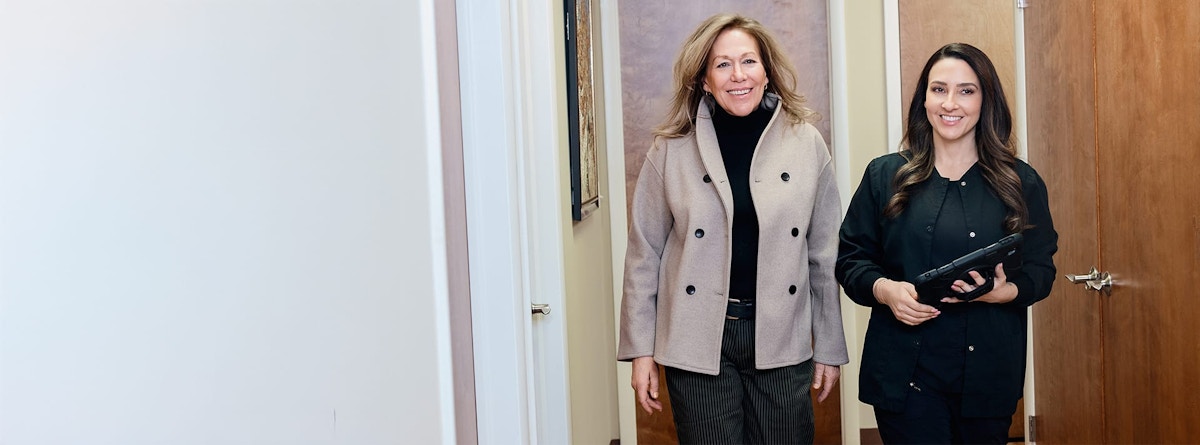 two women walking down a hallway