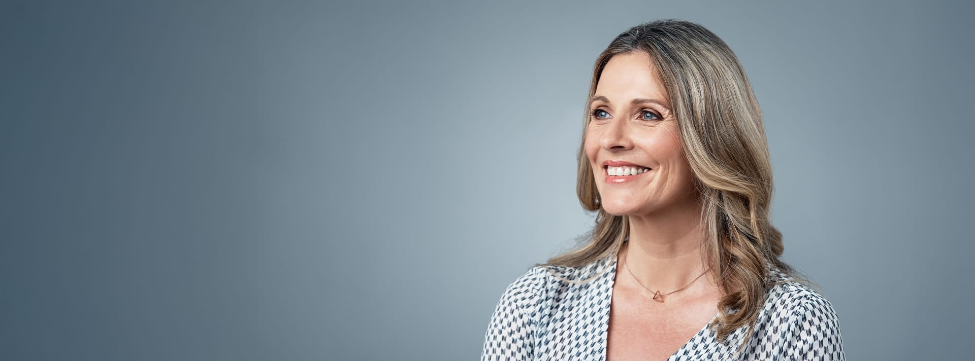 woman in checkered shirt smiling