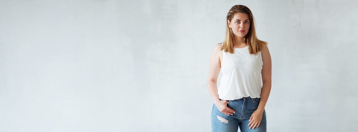 woman standing with her hand in her pocket