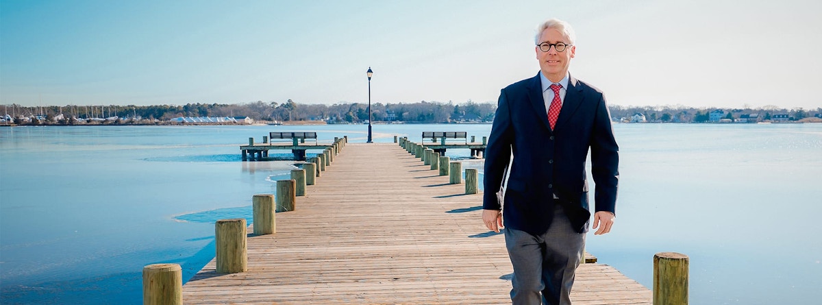 Dr. Stephen Small walking on a pier