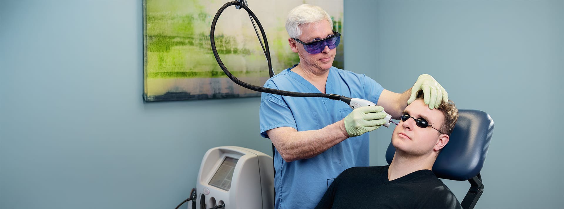doctor giving a patient a laser treatment