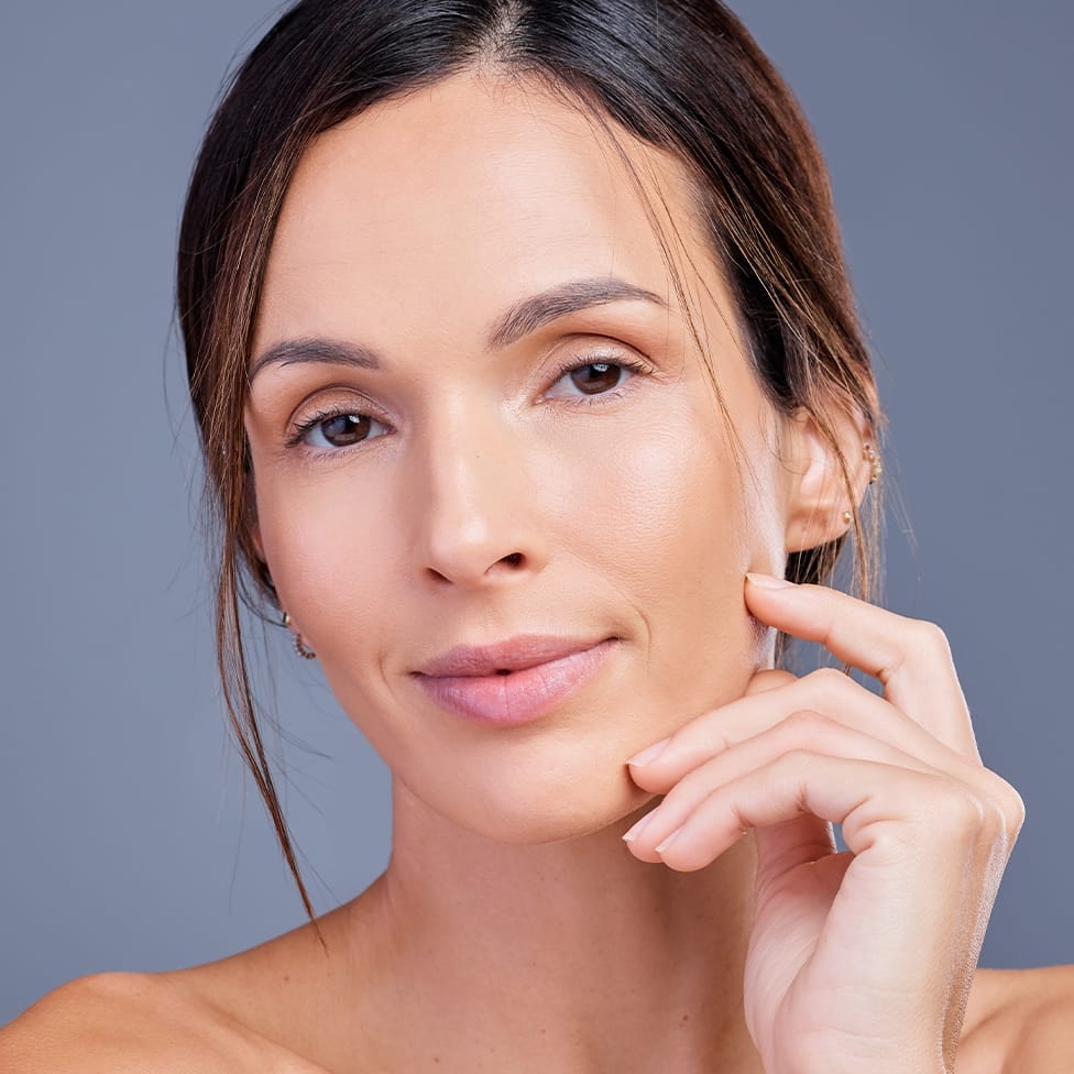 woman with her hand up near her face
