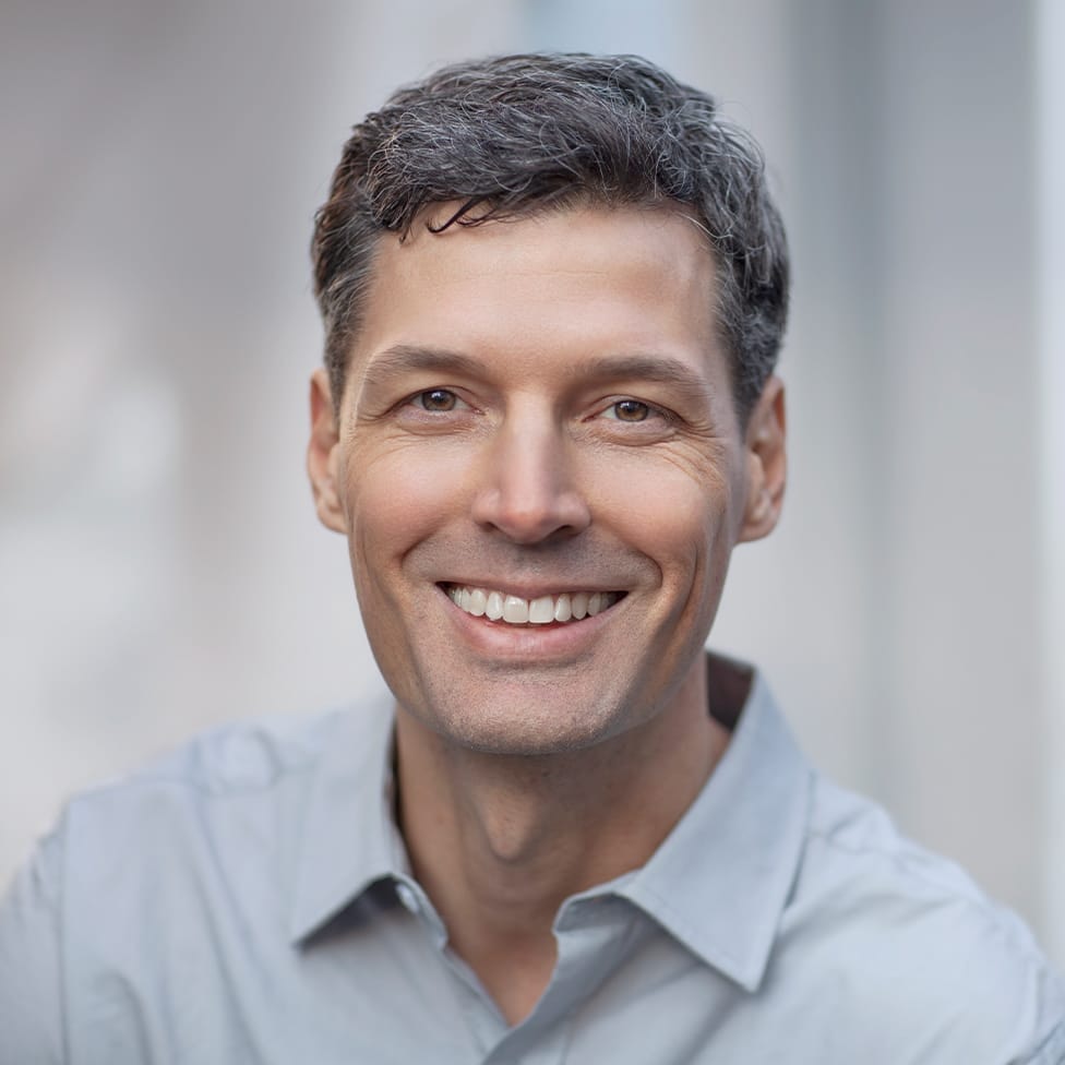 man smiling in collared shirt