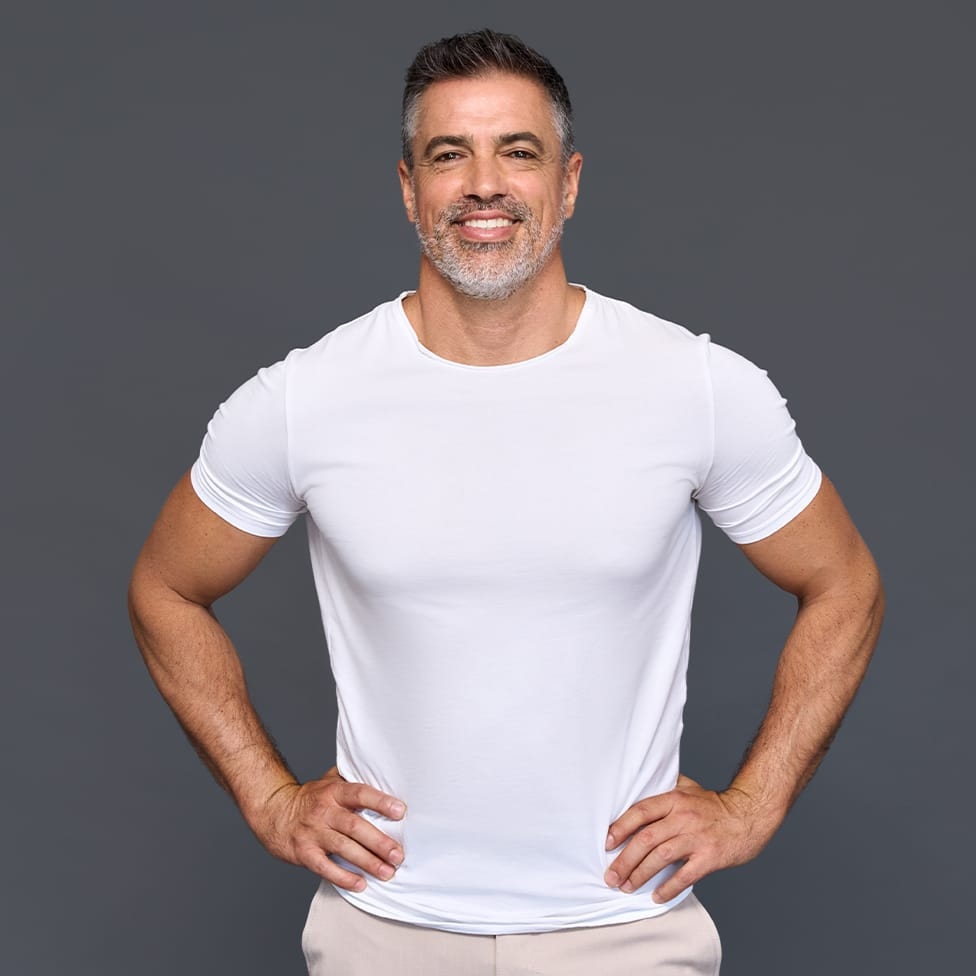 man smiling with his hands on his hips