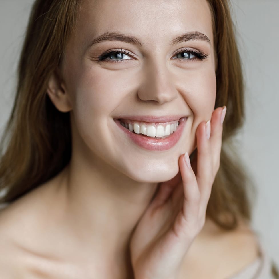 woman touching her face