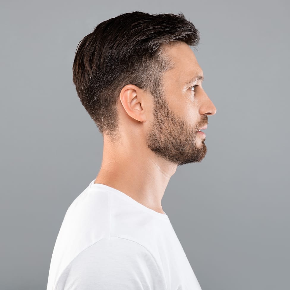 side profile of a man wearing a whitte t-shirt