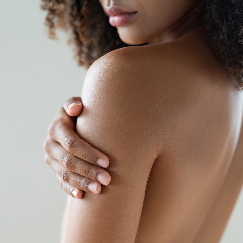 woman touching her arm