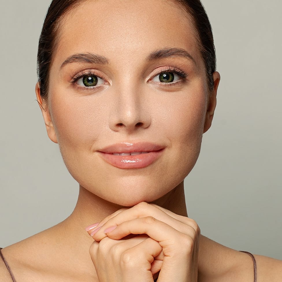 woman resting her chin on her knuckles