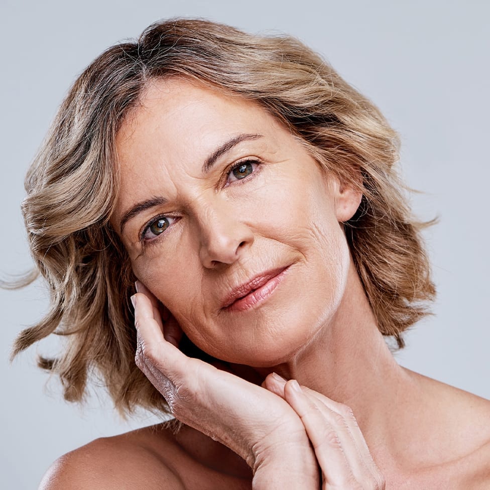 Woman with hands on cheek and chin