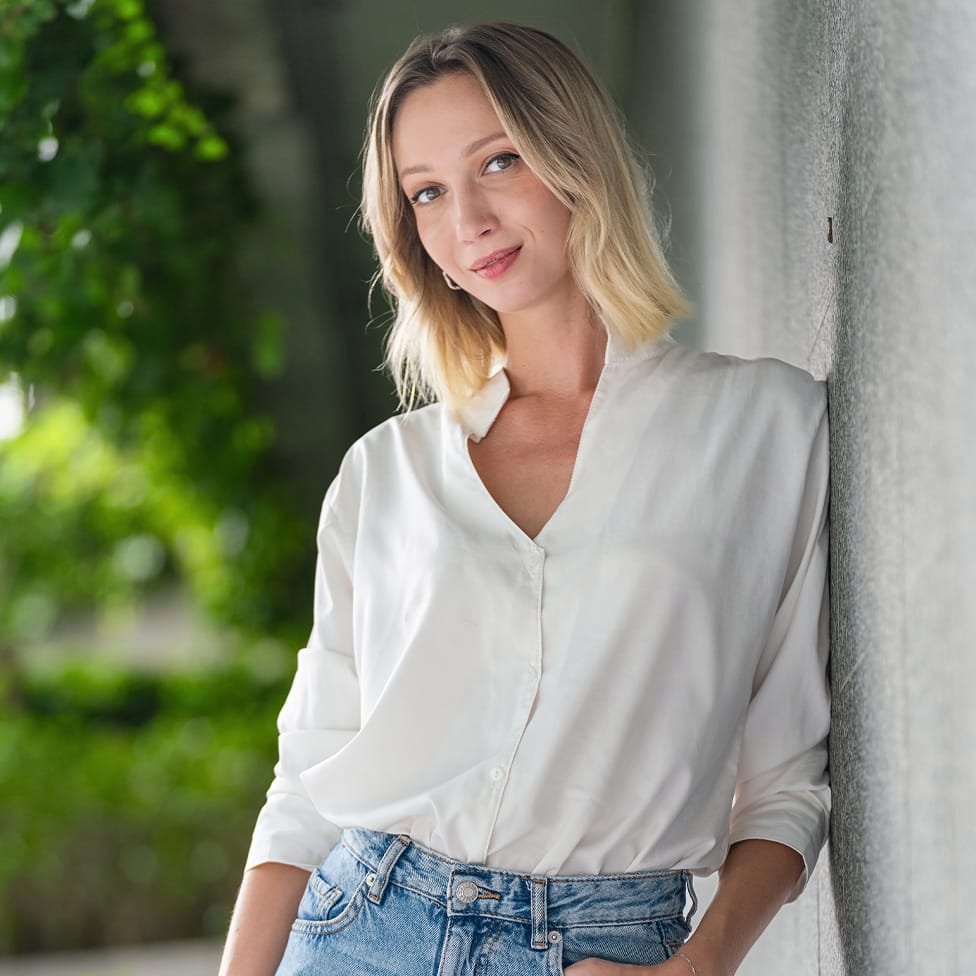 woman leaning against a wall