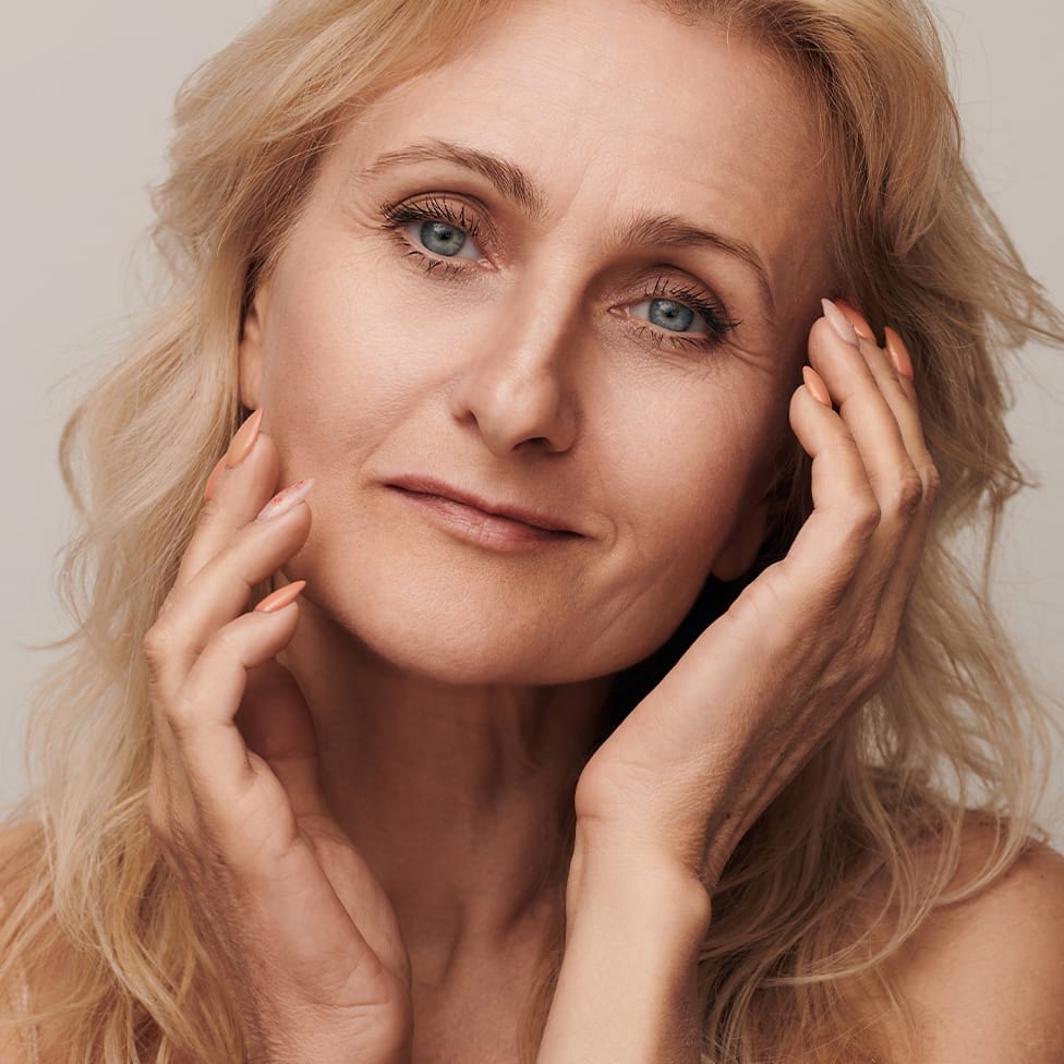 woman with her hands touching her face