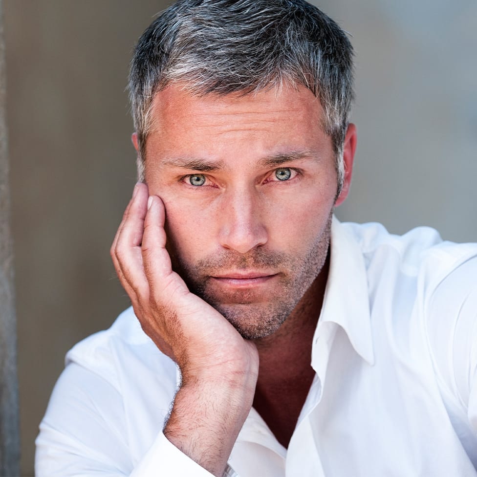 man resting his face in his hand