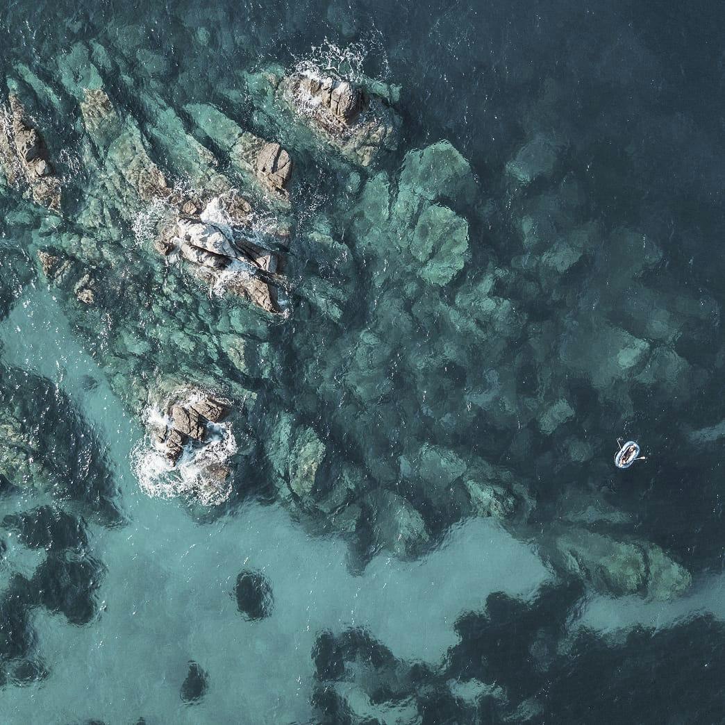 birds eye view of big rocky formations under the water