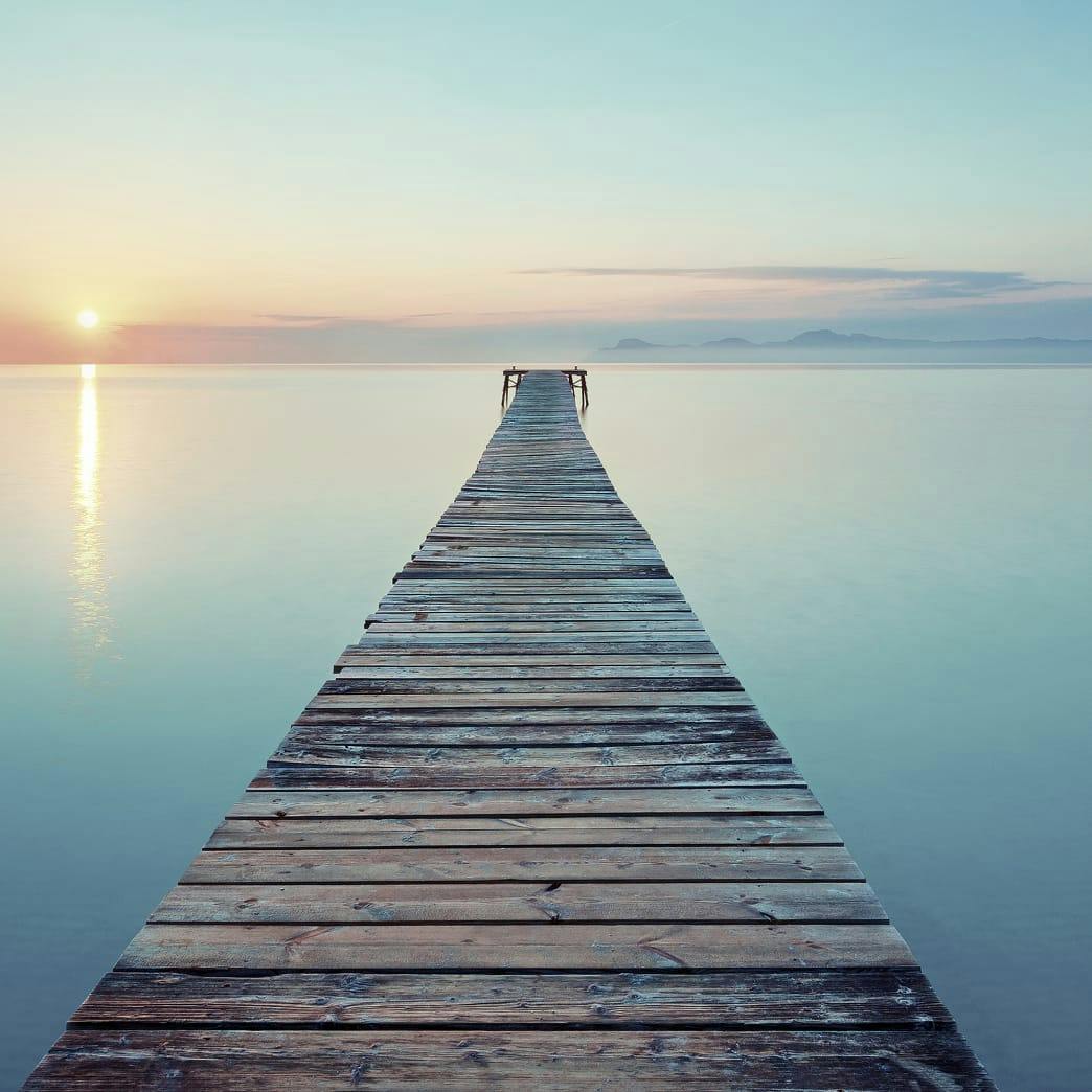 long wooden bridge on the water