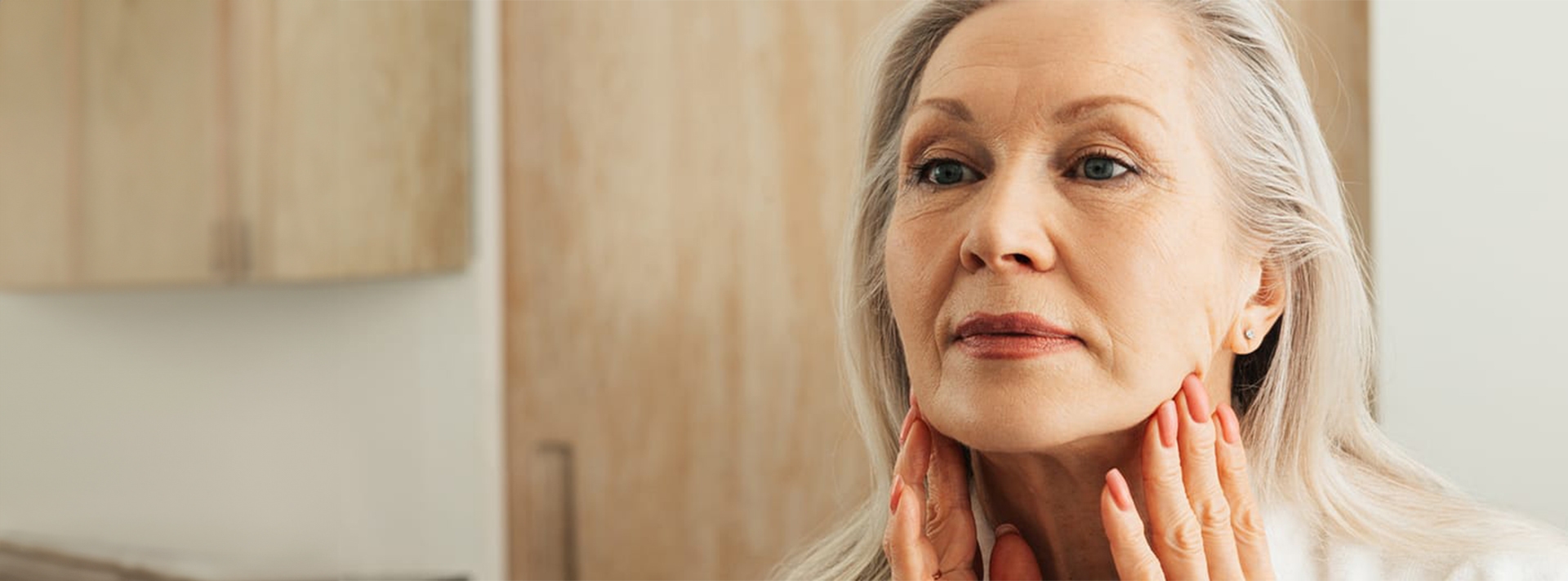 woman touching her lower face