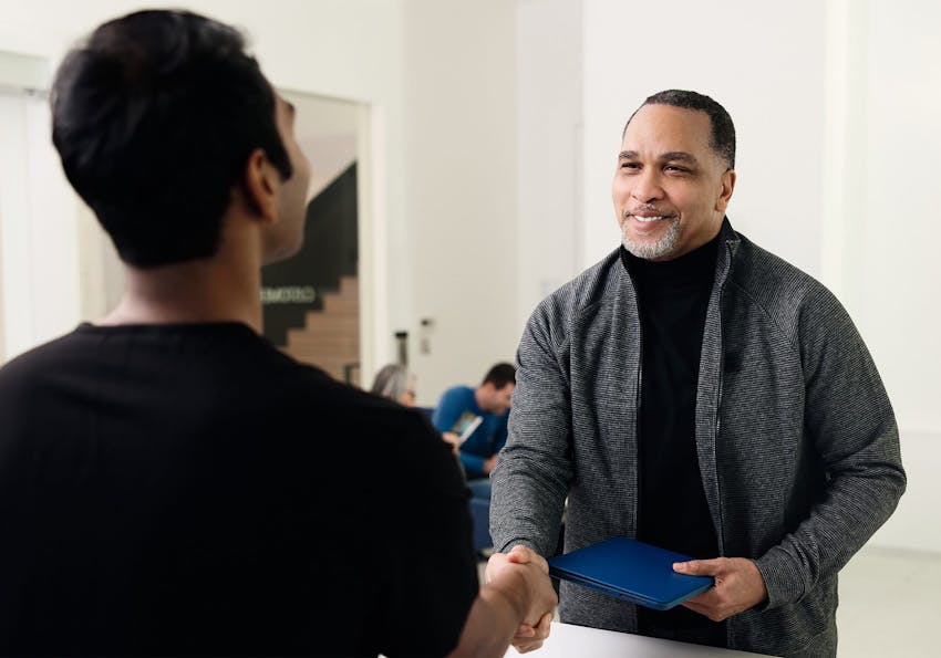 patient shaking hands with a nurse